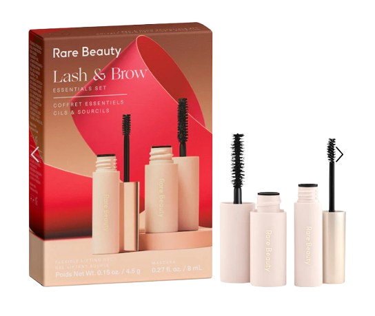 Rare Beauty Lash & Brow Essentials Set showing a mascara and brow gel in soft pink tubes beside the rose-gold gift box, designed to lift lashes and sculpt brows.