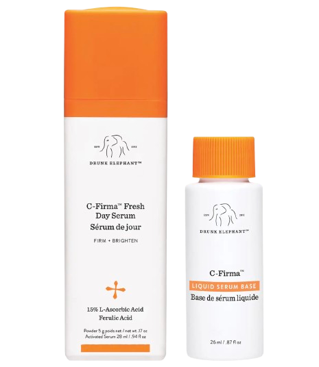 Drunk Elephant C-Firma Fresh Day Serum system with a tall white bottle and orange cap alongside the liquid serum base, designed to be mixed fresh for vitamin C potency.