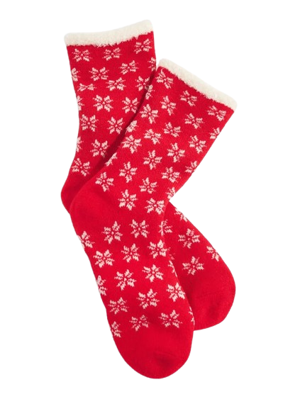 Pair of bright red trouser-length socks featuring white Fair Isle snowflake pattern with cream sherpa cuff trim at top.