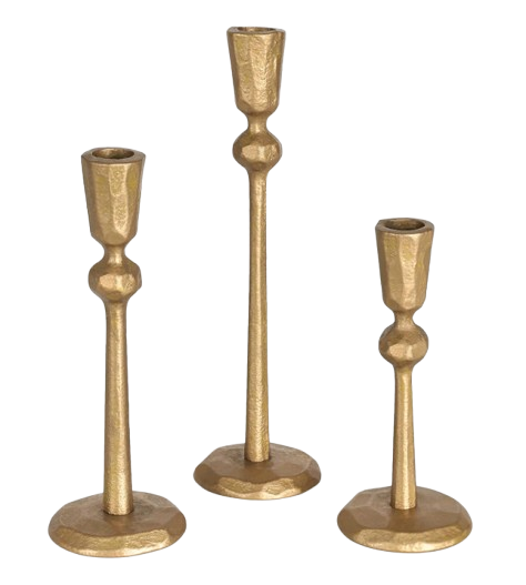 Set of three hammered brass candlestick holders in varying heights, featuring a warm gold finish and sculptural, minimalist design.