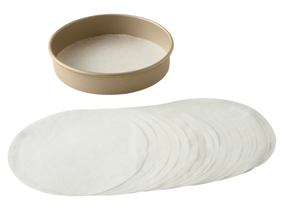 Stack of pre-cut round parchment paper liners displayed beside a gold cake pan, ideal for lining cake pans and baking evenly.