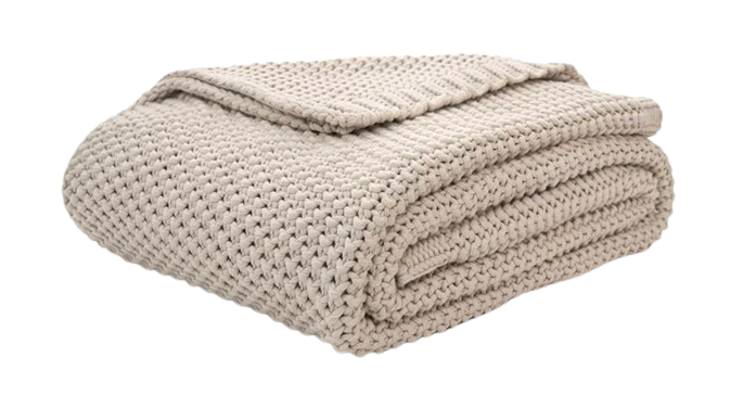 Organic cotton chunky knit throw blanket in a soft neutral shade, featuring a thick woven texture for cozy layering on sofas or beds.