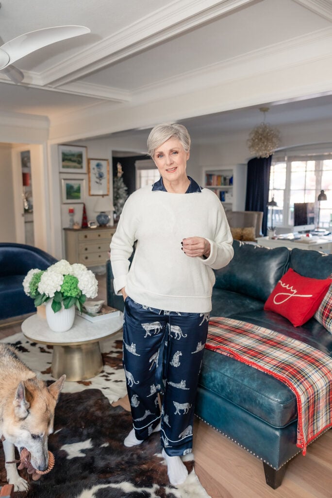 Beth Djalali wearing cream cashmere sweater layered over navy silk pajama set with snow leopard print piping details German Shepherd Oscar