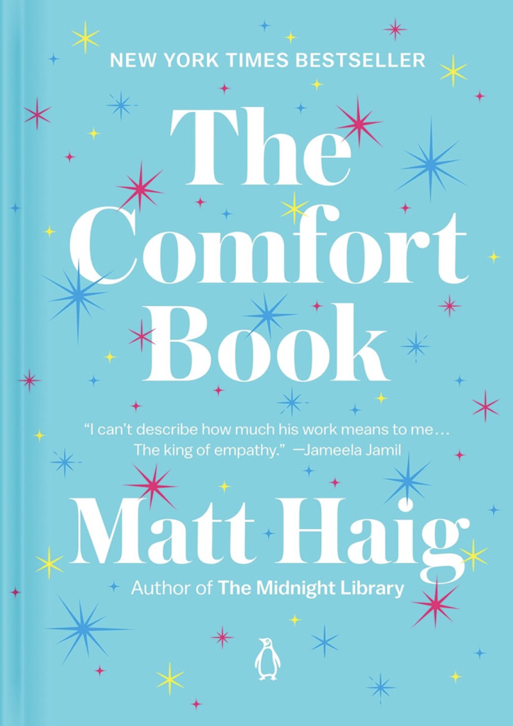 Cover of The Comfort Book by Matt Haig, featuring a bright blue background with colorful star illustrations and large white title text.