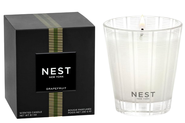 Nest Fragrances Grapefruit scented candle with white wax in a clear etched glass vessel, shown beside its black and gold gift box.