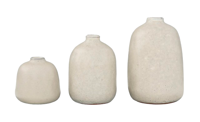 Set of three matte terracotta vases in soft neutral tones, displayed in graduated sizes with rounded silhouettes and a lightly textured, handmade finish.