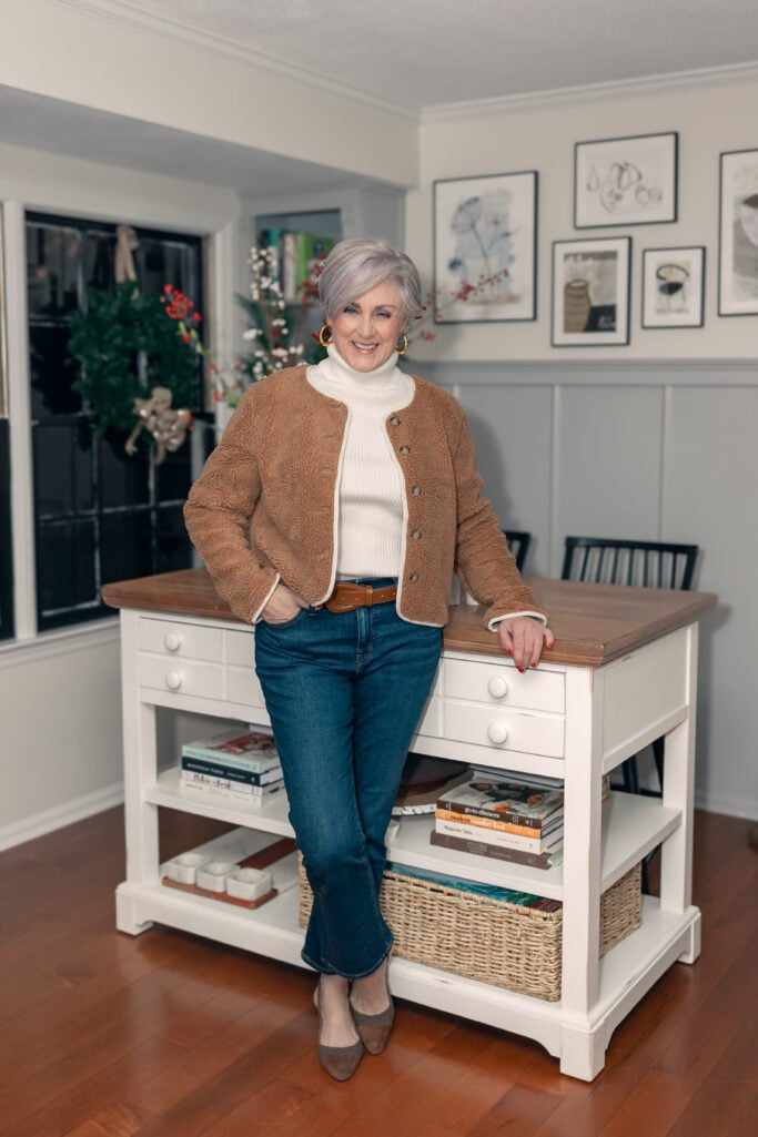 Casual chic sherpa jacket outfit with bootcut jeans and cream turtleneck for women over 50
