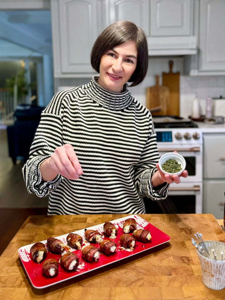Woman wearing a black and white fine horizontal striped rollneck sweater, showcasing how thin stripes create a sophisticated and versatile base layer for multiple outfit options.