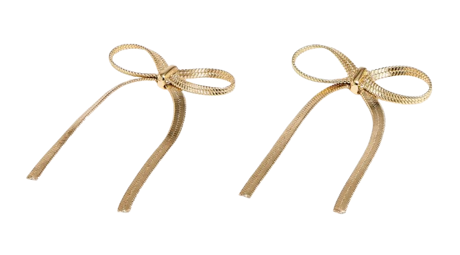 Gold metallic bow earrings with textured ribbon-like loops and long, slim tails that dangle below the ear. Lightweight statement earrings with a polished finish and playful, feminine silhouette.