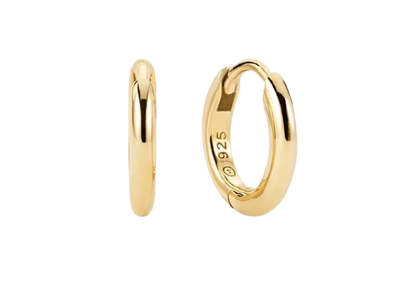 Pair of Mejuri gold huggie hoop earrings shown from front and side views. Small, polished hoops with a hinged closure and smooth, minimalist design suitable for everyday wear.