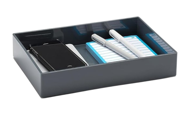 Rectangular dark gray desk accessory tray holding a smartphone, notepad, and pens, designed for organizing small office essentials.