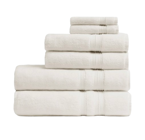 Stack of plush Parachute Classic Bath Towels in soft ivory cotton with ribbed band detailing, thick and absorbent for a hotel-quality bathroom feel.
