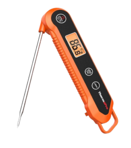 ThermoPro digital instant-read meat thermometer with bright orange handle, fold-out stainless steel probe, and backlit LCD screen displaying internal temperature reading.