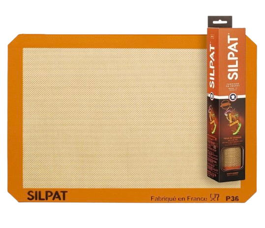 Silpat reusable silicone baking mat with orange border and nonstick mesh center, half-sheet size for lining baking pans and preventing sticking without parchment.