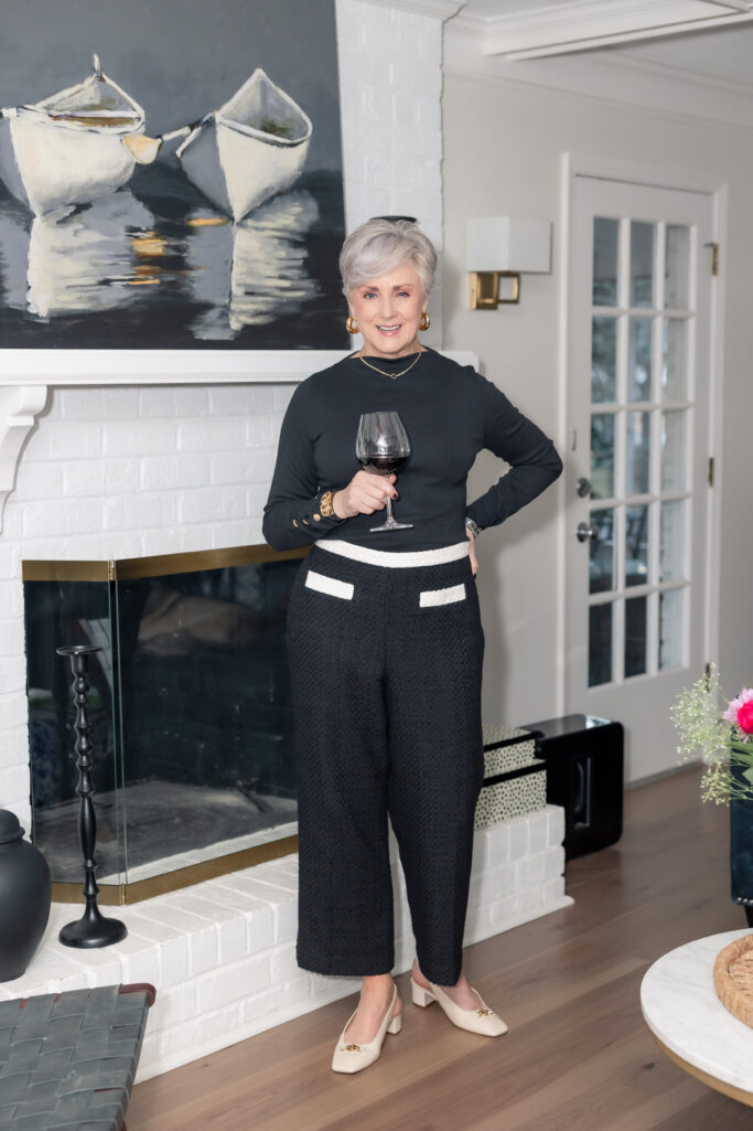 Black tweed wide-leg culottes with cream trim + black long-sleeve top + cream slingbacks + gold earrings + wine optional