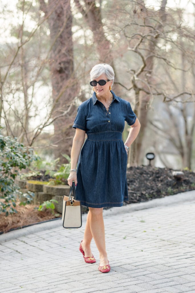 Denim shirtdress + red woven flats + structured two-tone bag + gold earrings + cat-eye sunglasses