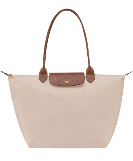 Beige Longchamp Le Pliage large tote with brown leather handles and flap closure, lightweight nylon body, and gold snap detail.