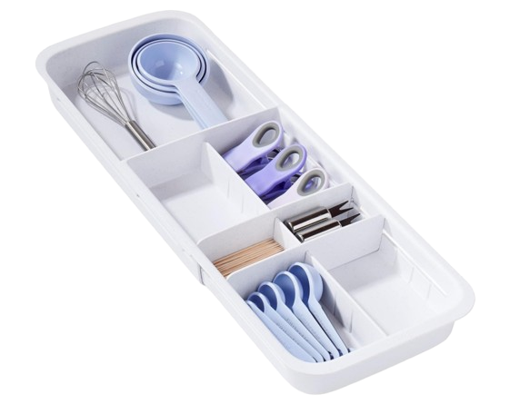Expandable white kitchen drawer organizer with multiple compartments holding measuring spoons, scissors, clips, and kitchen tools for tidy utensil storage.