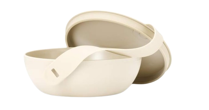 W&P Porter reusable food bowl in a minimalist cream color with matching lid and strap, designed for storing and transporting salads, grain bowls, and leftovers.
