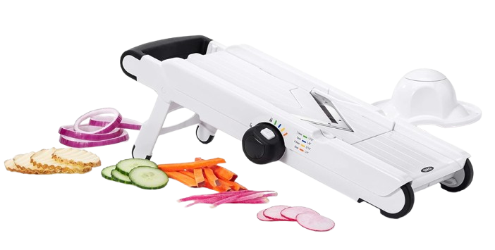 OXO Good Grips V-blade mandoline slicer with adjustable thickness dial, shown slicing cucumbers, carrots, radishes, and onions for quick vegetable prep.