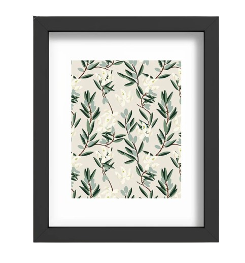 Framed botanical art print featuring a repeating pattern of green leafy branches and white blossoms on a neutral background, set in a black frame with white mat.