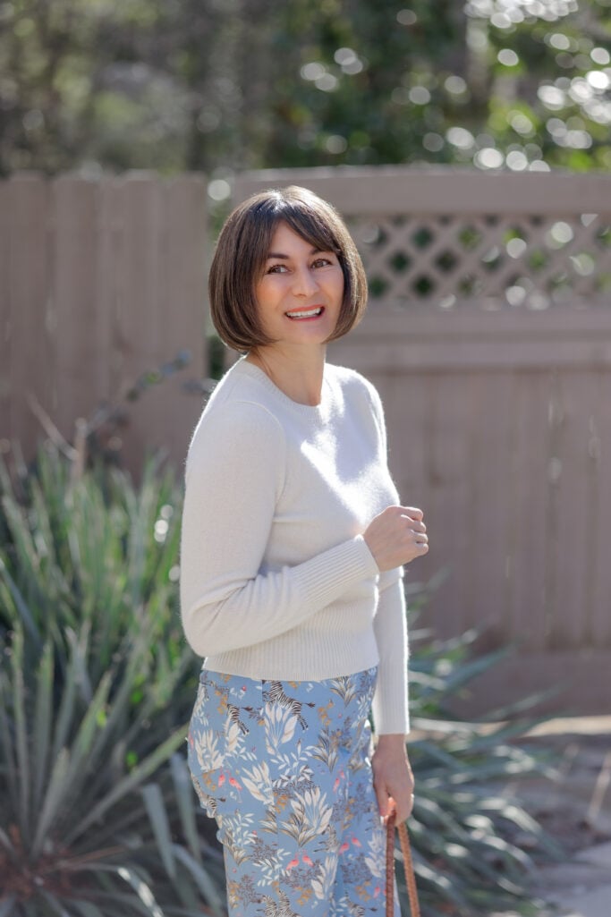 cashmere sweater fit on petite frame styled with high-waisted printed pants