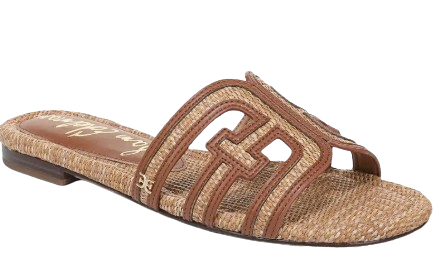 Sam Edelman Bay slide sandal with woven raffia footbed and brown leather cutout straps in a warm cognac tone, flat slip-on summer sandal.