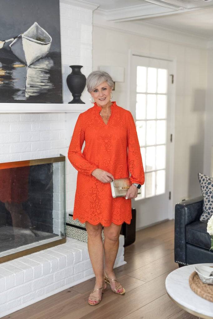 Beth in an orange Talbots lace shift dress with gold sandals — spring dresses for women over 50