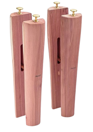 Set of cedar wood shoe trees with brass knobs, designed to maintain shoe shape and absorb moisture.