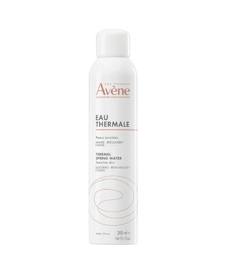 White aerosol can of Avène Thermal Spring Water facial mist, shown with water droplets to highlight its soothing, calming properties for sensitive skin.