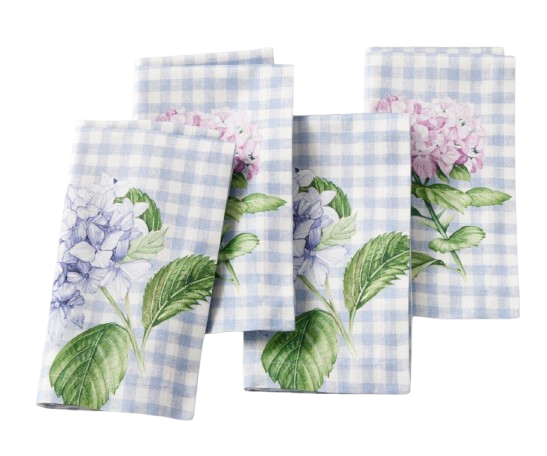 Set of four folded cotton napkins with pale blue gingham pattern and watercolor hydrangea floral prints in blue and pink, arranged on a marble surface.