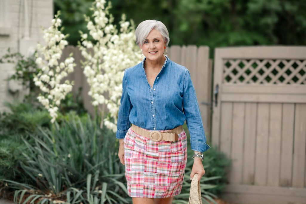 Beth Djalali wearing a denim shirt and plaid skirt for modern grandmother outfit ideas