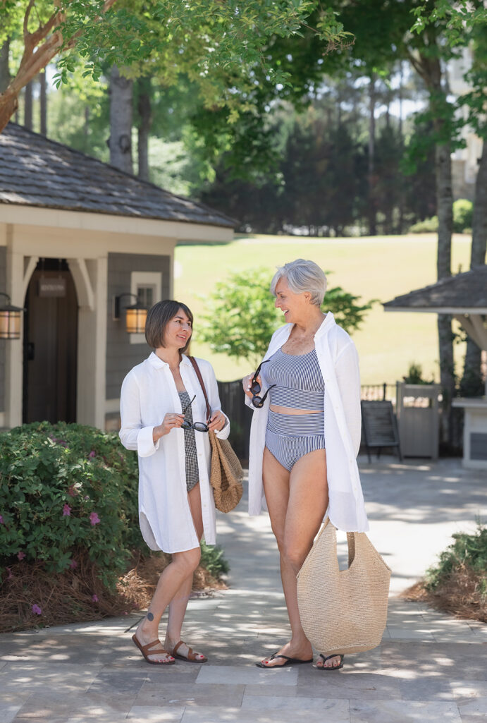 Kelly and Beth at a resort wearing swimsuits and white linen cover-ups — petite swimwear for women over 50