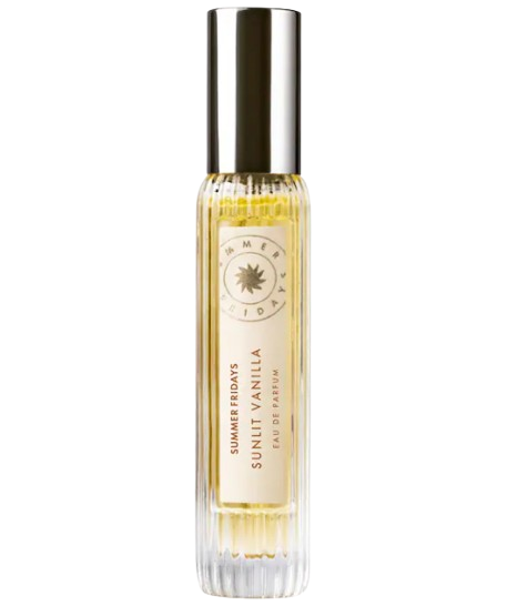 Summer Fridays Sunlit Vanilla Eau de Parfum travel spray with clear fluted glass bottle, pale golden liquid, and metallic cap, warm gourmand fragrance with notes of vanilla, caramel, and bergamot.