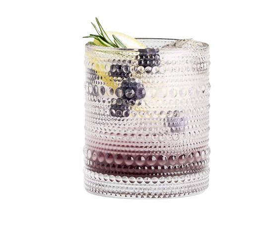 Textured clear Alma double old-fashioned glass with a blackberry cocktail, lemon slices, rosemary garnish, and ice against a white background.