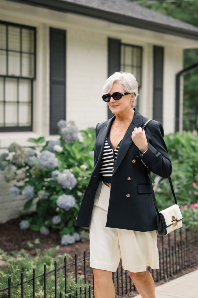Double-faced Bermuda shorts with a striped knit vest and a tailored blazer