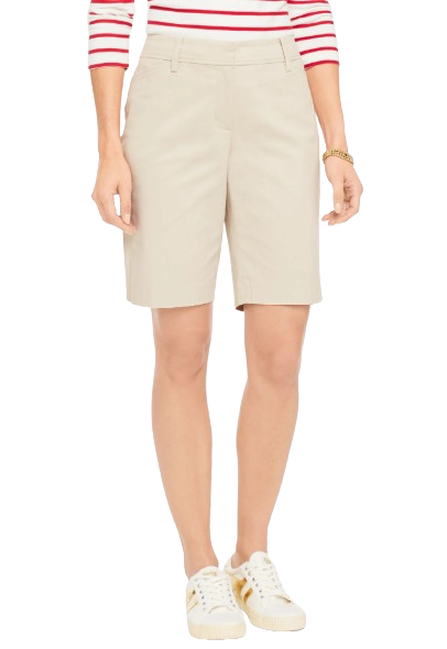 Khaki chino shorts with a tailored silhouette, front pockets, and a knee-grazing length styled with white sneakers.