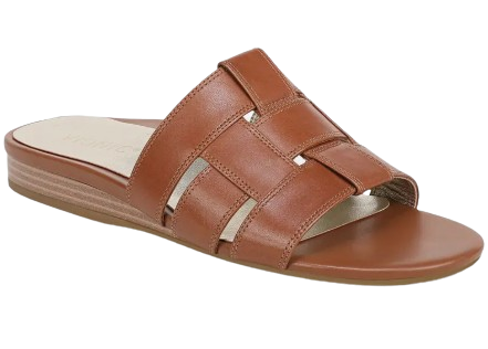 Tan leather slide sandal featuring wide cutout straps, metallic underlay accents, and a low stacked heel for polished everyday wear.