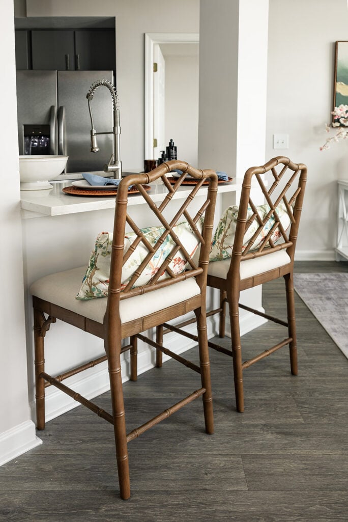 Woven rattan counter stools at the kitchen island in Beth's new Atlanta apartment