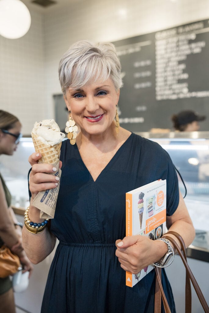 Beth wearing statement earrings and eating an ice cream
