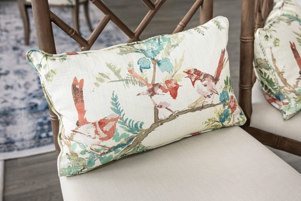 Bar stools with a botanical floral lumbar pillow in the apartment living room