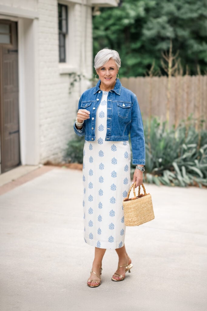Beth Djalali in a blue block-print midi dress with a cropped denim jacket and straw bag — one printed piece as the star