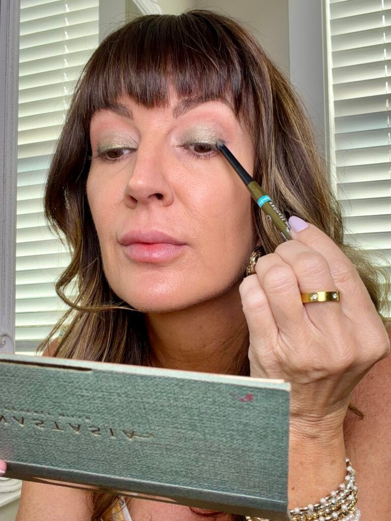 olive eyeshadow look with brown eyeliner applied
