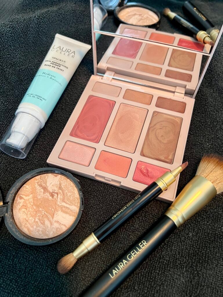 Flatlay of the Laura Geller Best of the Best Cream Starter Kit palette, foundation, and brushes