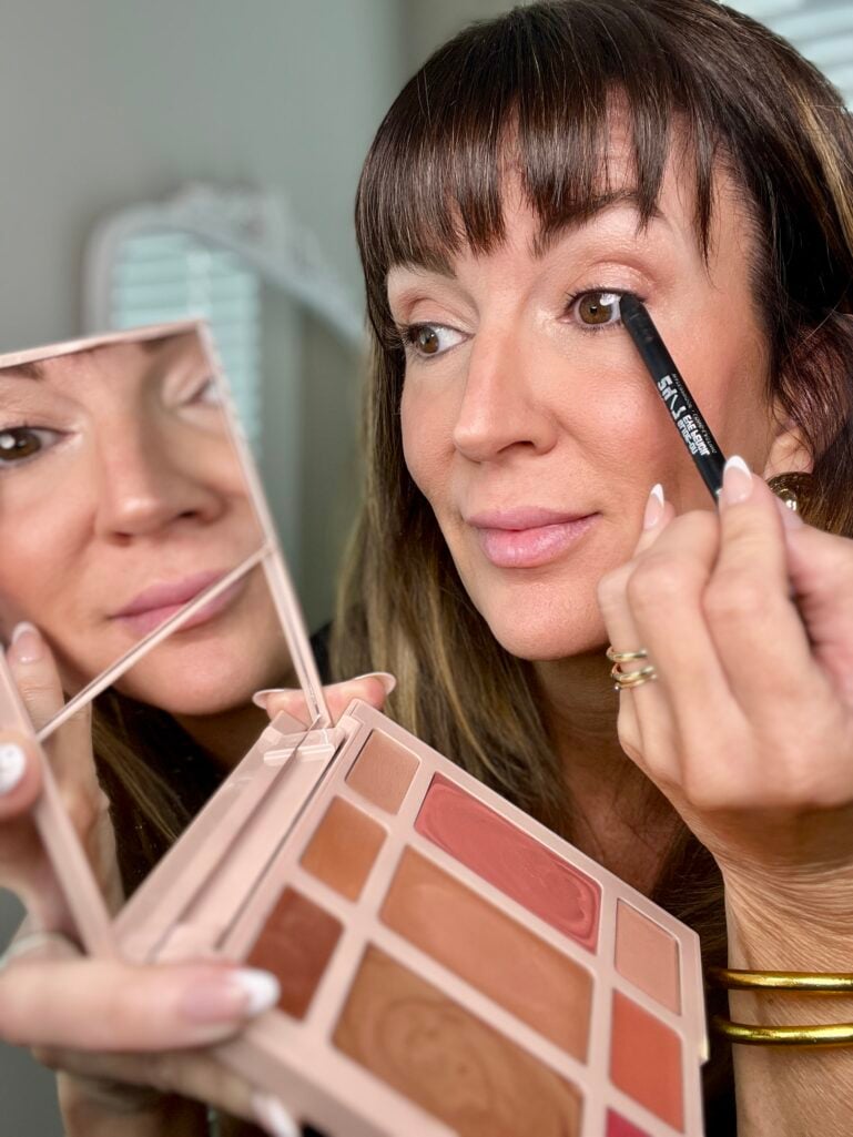 Using the built-in magnifying mirror in the Laura Geller cream palette