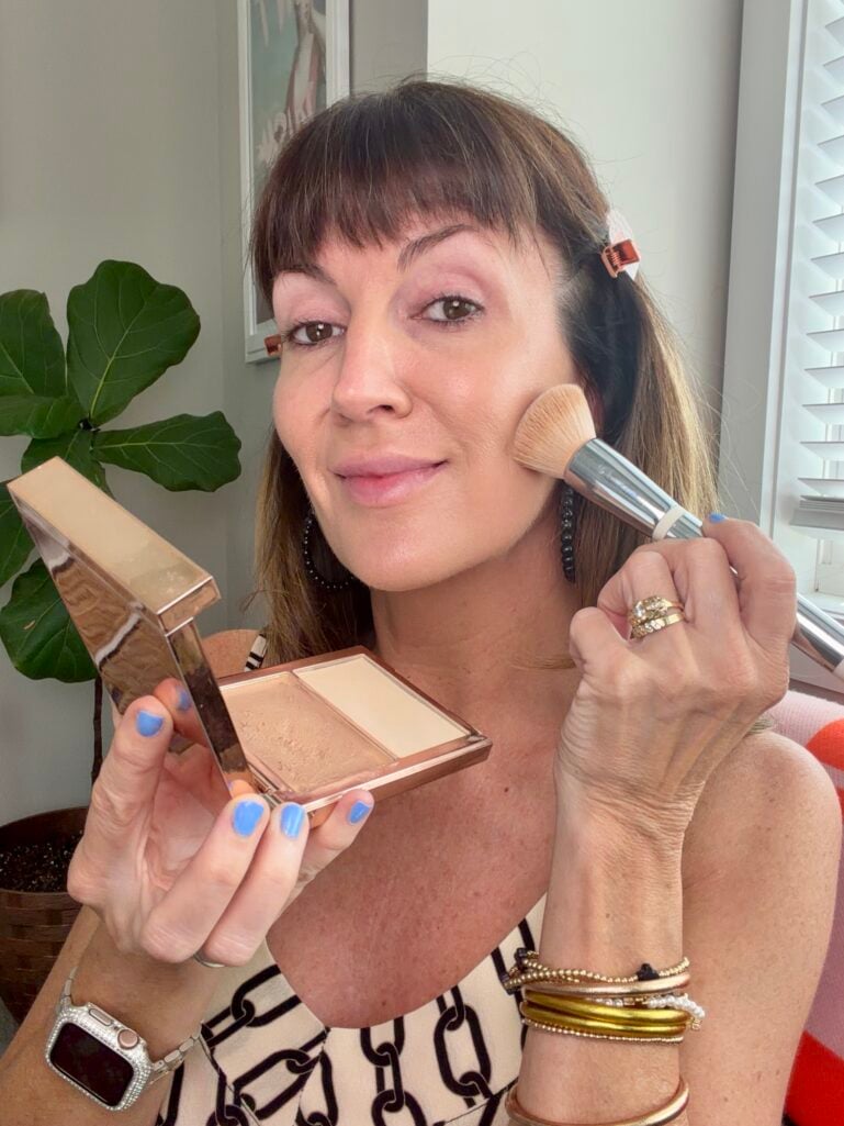 Applying cream foundation and powder duo for even skin tone over 50.