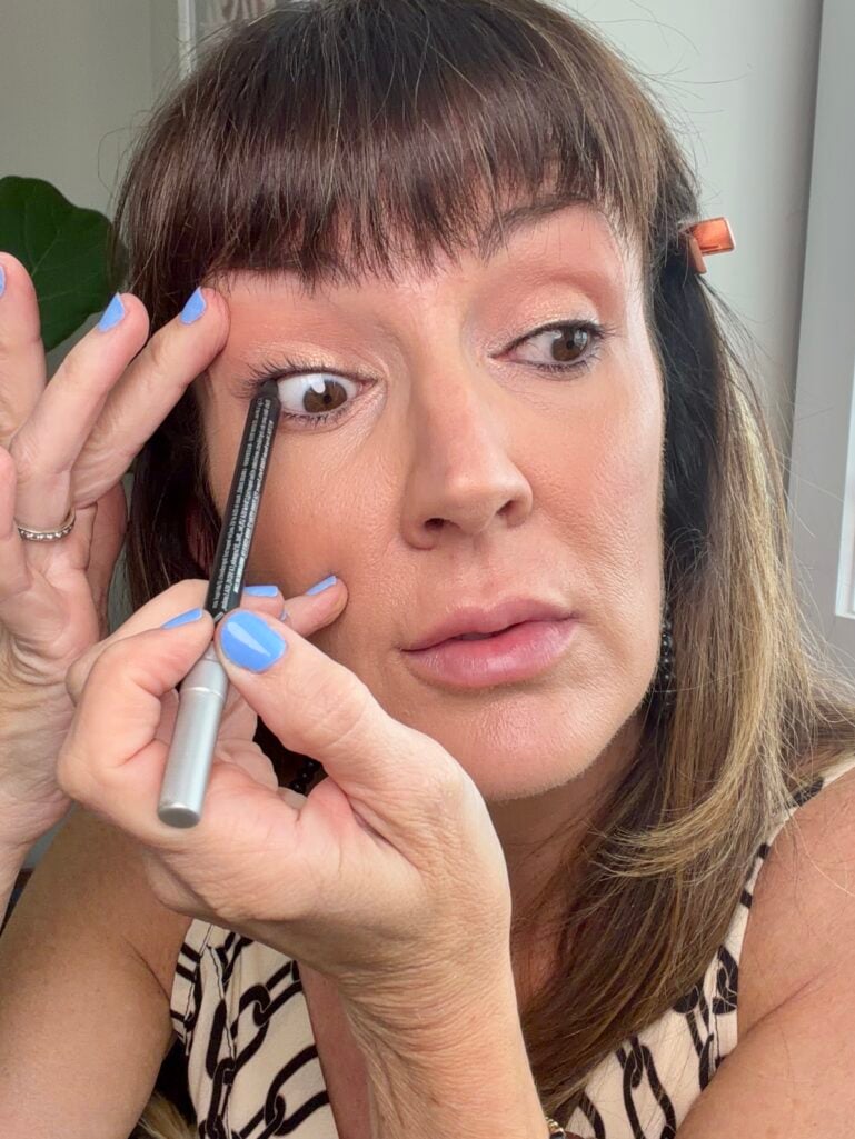 Tightlining upper waterline with black waterproof eyeliner.