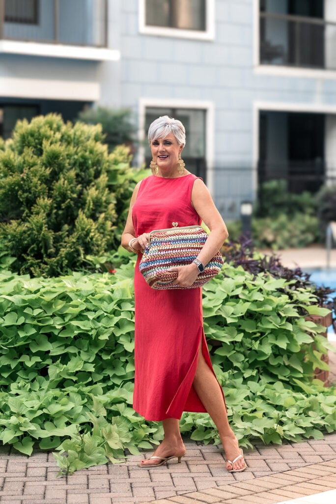 Full-length view of coral linen midi skirt and tank top from Gap styled with gold thong sandals