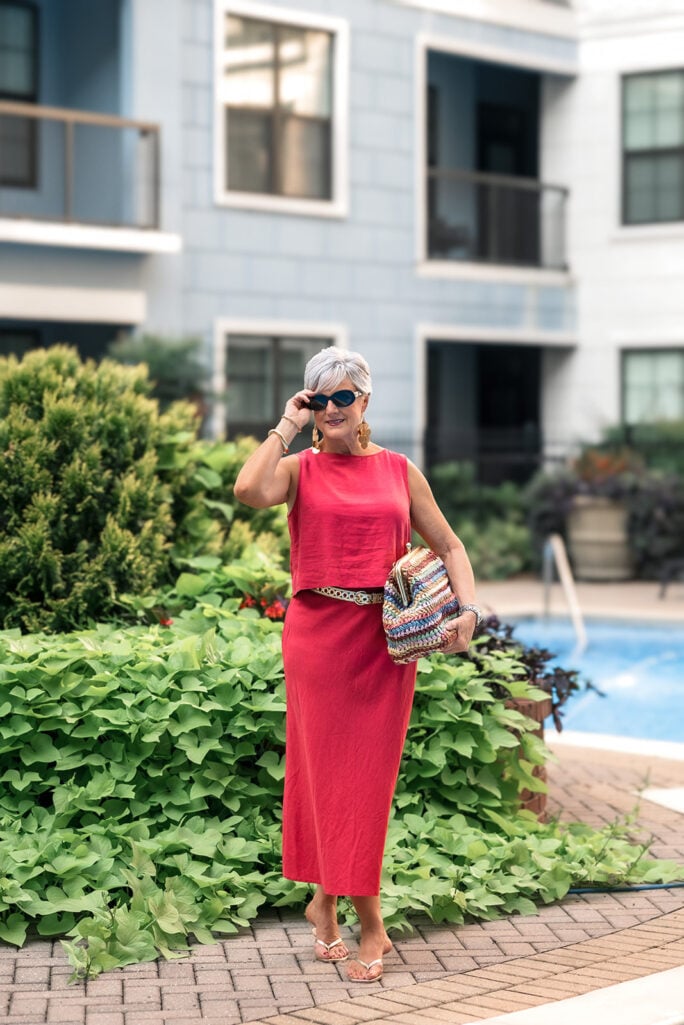 Side profile of coral linen Gap outfit showing the midi skirt's side slit and drape